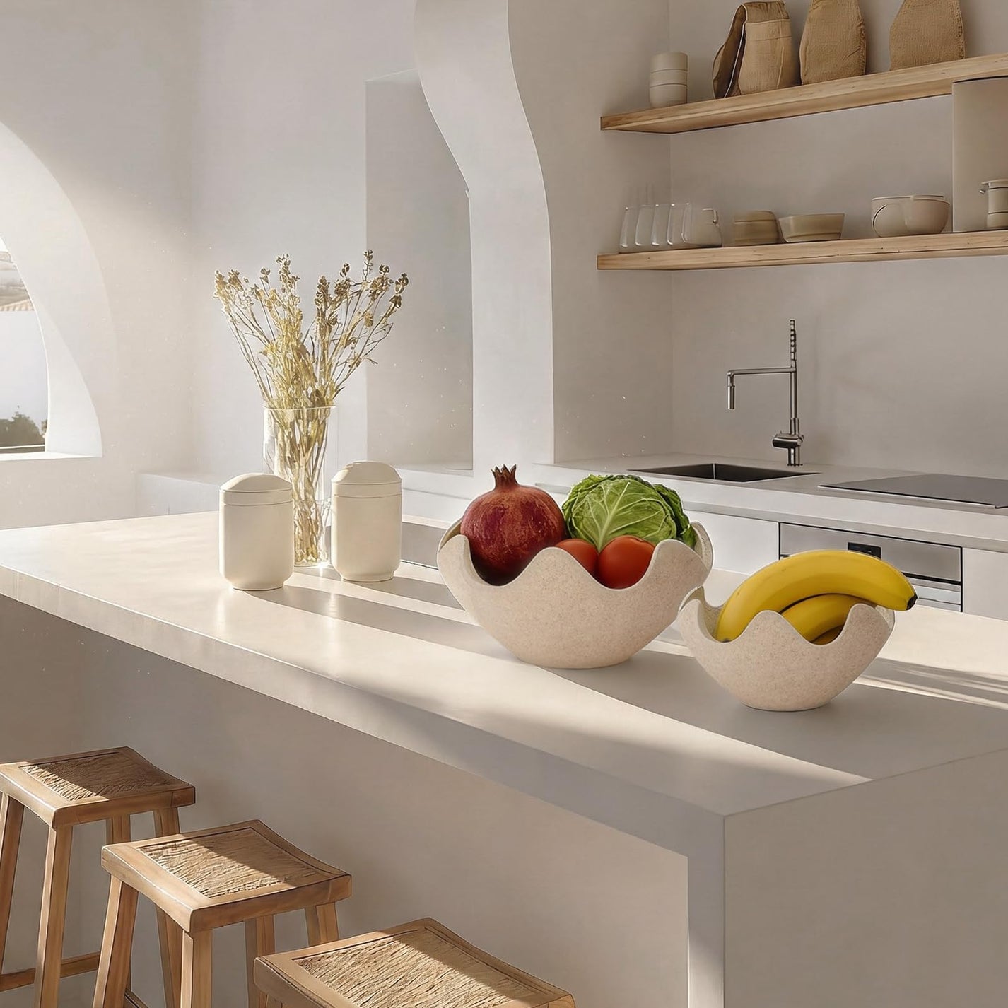 Minimalist kitchen counter with fruit bowls, dried flowers, and stools. Decorating on a budget.